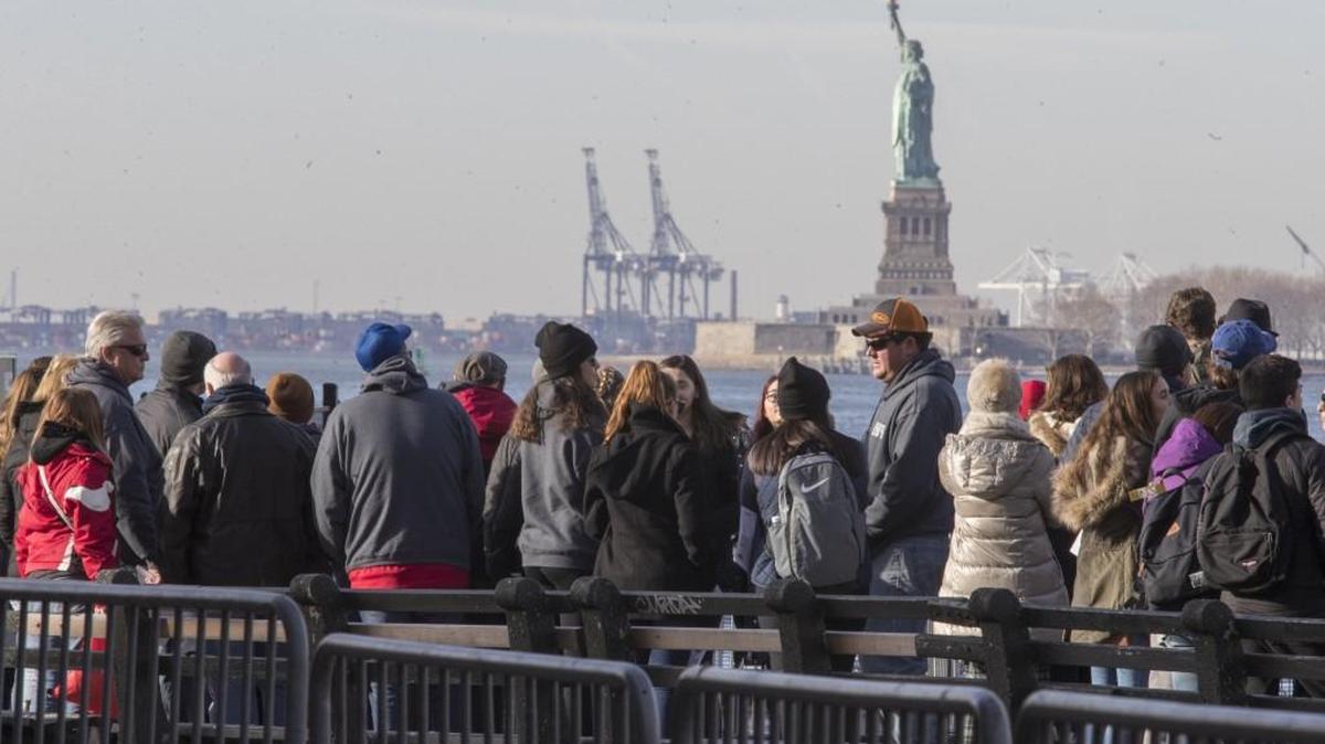 Visitors to the Statue of Liberty stand in line to board a ferry that will cruise the bay around the statue and Ellis Island, Saturday, Jan. 20, 2018, in New York. The National Park Service announced that the Statue of Liberty and Ellis Island would be closed Saturday “due to a lapse in appropriations.” Late Friday, the Senate failed to approve legislation to keep the government from shutting down after the midnight deadline.