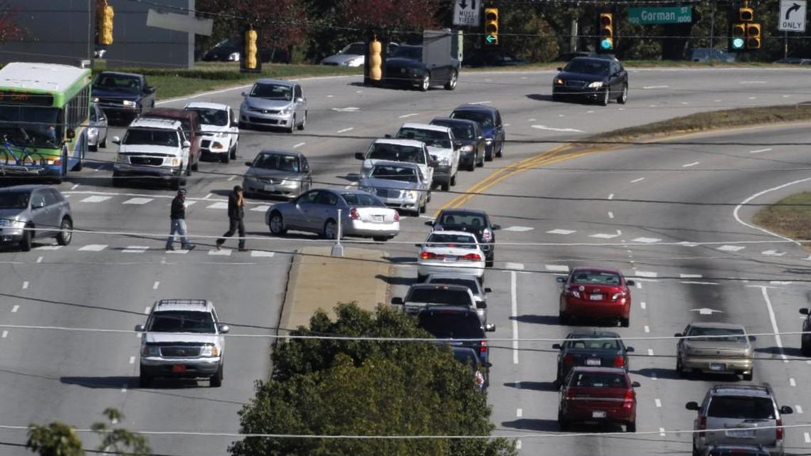 Pedestrians cross on a busy roadway