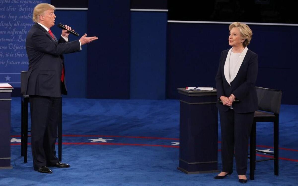 Republican presidential candidate Donald Trump speaks as Democratic candidate Hillary Clinton listens during the second U.S. presidential debate at Washington University in St. Louis.