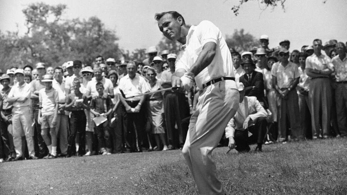 This April 29, 1962, file photo shows Arnold Palmer, lifting an iron shot from No. 5 fairway in the final round of the Texas Open in San Antonio. Palmer, who made golf popular for the masses with his hard-charging style, incomparable charisma and a personal touch that made him known throughout the golf world as “The King,” died Sunday, Sept. 25, 2016, in Pittsburgh. He was 87.