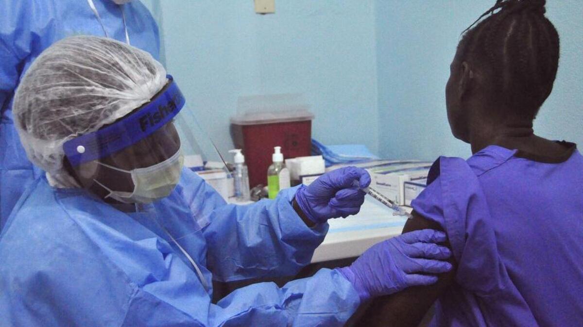 A woman is injected by a health care worker, left, as she takes part in an Ebola virus vaccine trial, at one of the largest hospital’s Redemption hospital in Monrovia, Liberia in 2015.