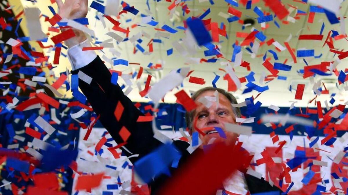 Democrat Doug Jones waves to supporters Tuesday, Dec. 12, 2017, in Birmingham, Ala. In a stunning victory aided by scandal, Jones won Alabama's special Senate election, beating back history, an embattled Republican opponent and President Donald Trump, who urgently endorsed GOP rebel Roy Moore despite a litany of sexual misconduct allegations.