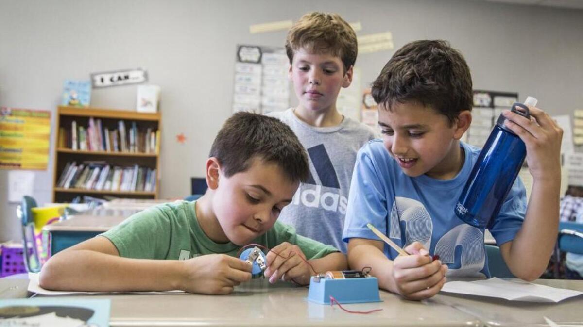 Fourth-graders from left, Lucas Bedont, Ryan Olson and Matthew LaRusso take part in a lesson on electrical circuits at Salem Elementary School in Apex Wednesday on April 12. Wake County commissioners have increased funding for the county’s growing school system.