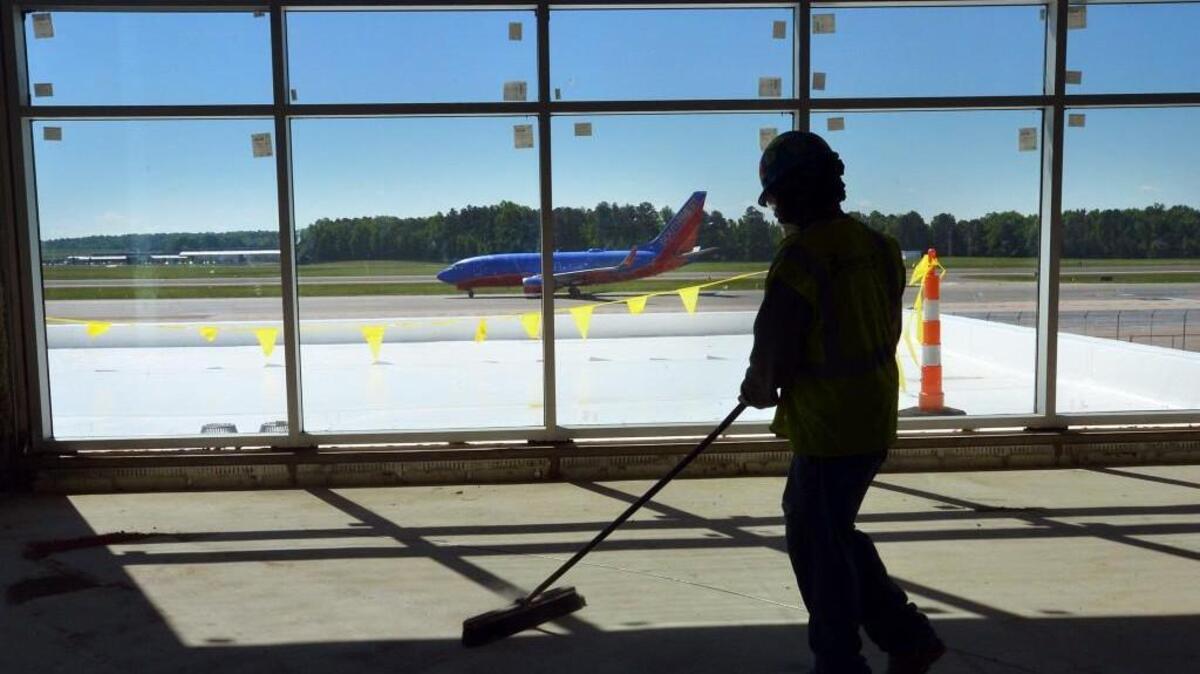 A worker sweeps up at RDU’s Terminal 1 during rennovations in 2013.