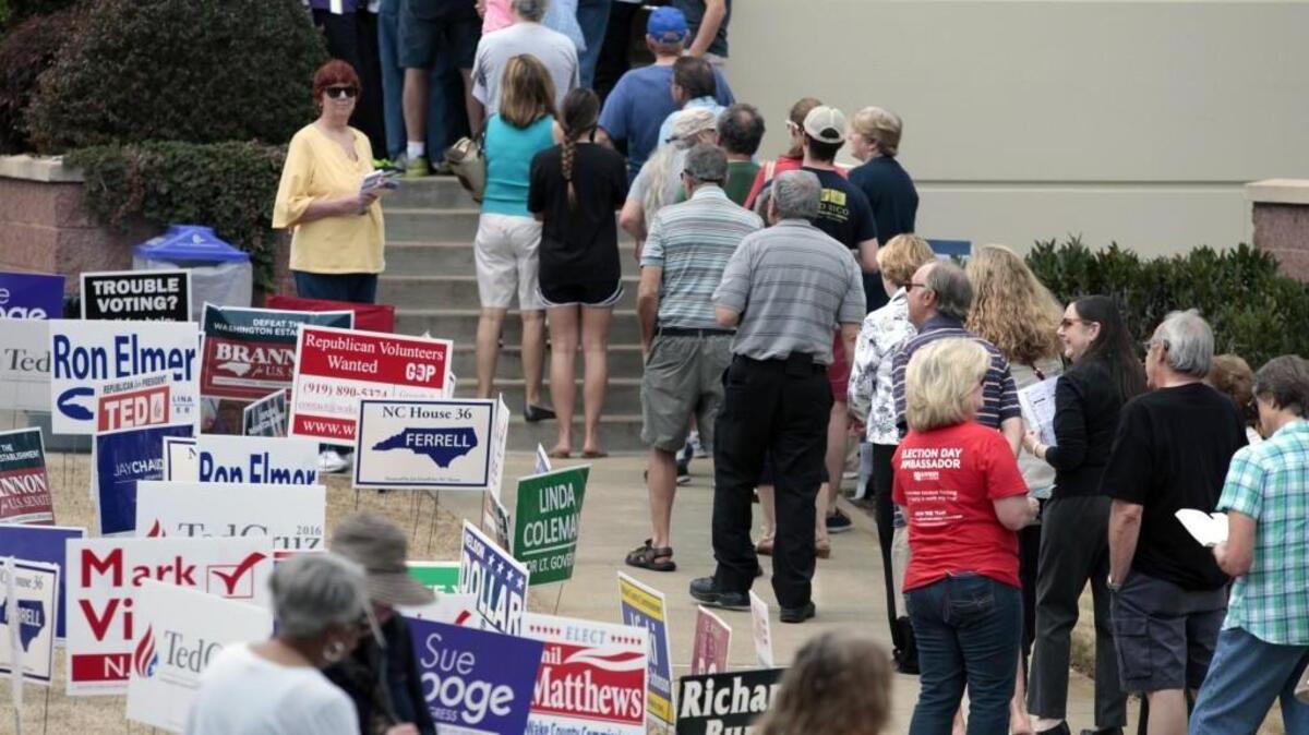 Wake county voters line up well out the front door at the Herbert C. Young Community Center early voting site during lunchtime in Cary, NC Friday, March 11, 2016. The Cary early voting site was second so far this month in voters processed behind only the Lake Lynn Community Center in Raleigh. Early voting ends Saturday with the normal primary election next Tuesday, March 15, 2016.