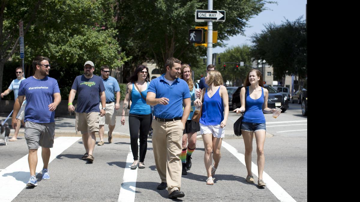 
Paddy O’Beers owner Zack Medford, center, leads a group of patio supporters to Raleigh City Hall for a committee meeting regarding potential changes in downtown patio seating on Tuesday
