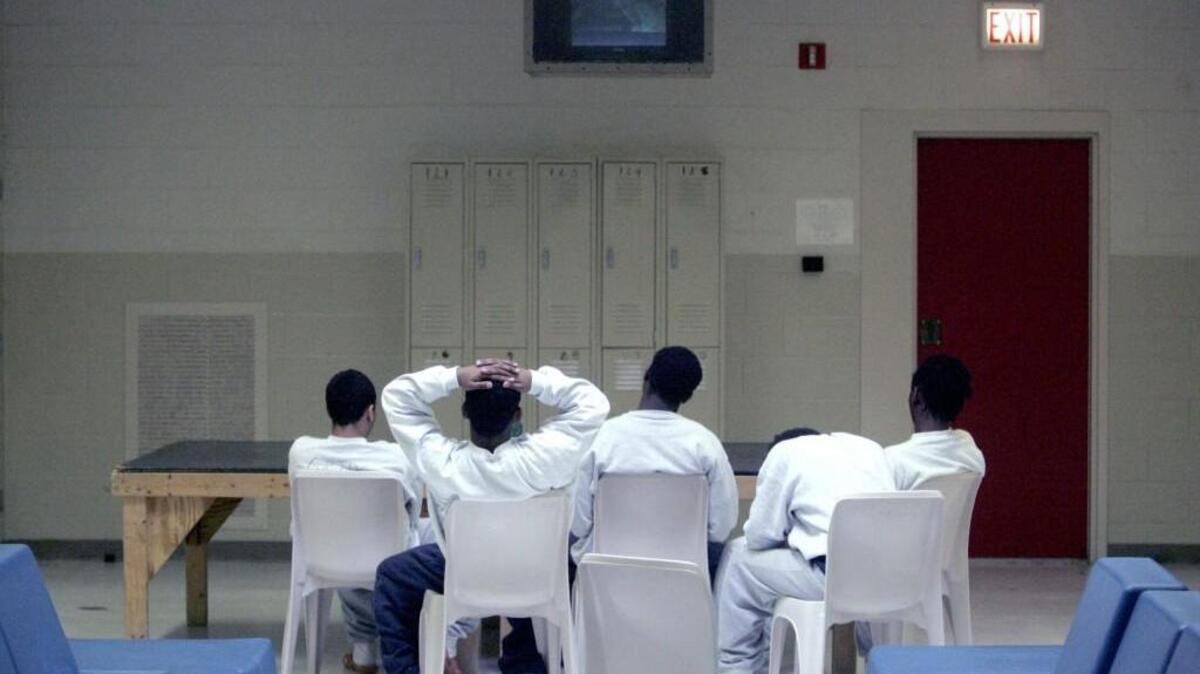 Juvenile offenders pass time watching television at the Polk Youth Institution juvenile detention facility in Butner.