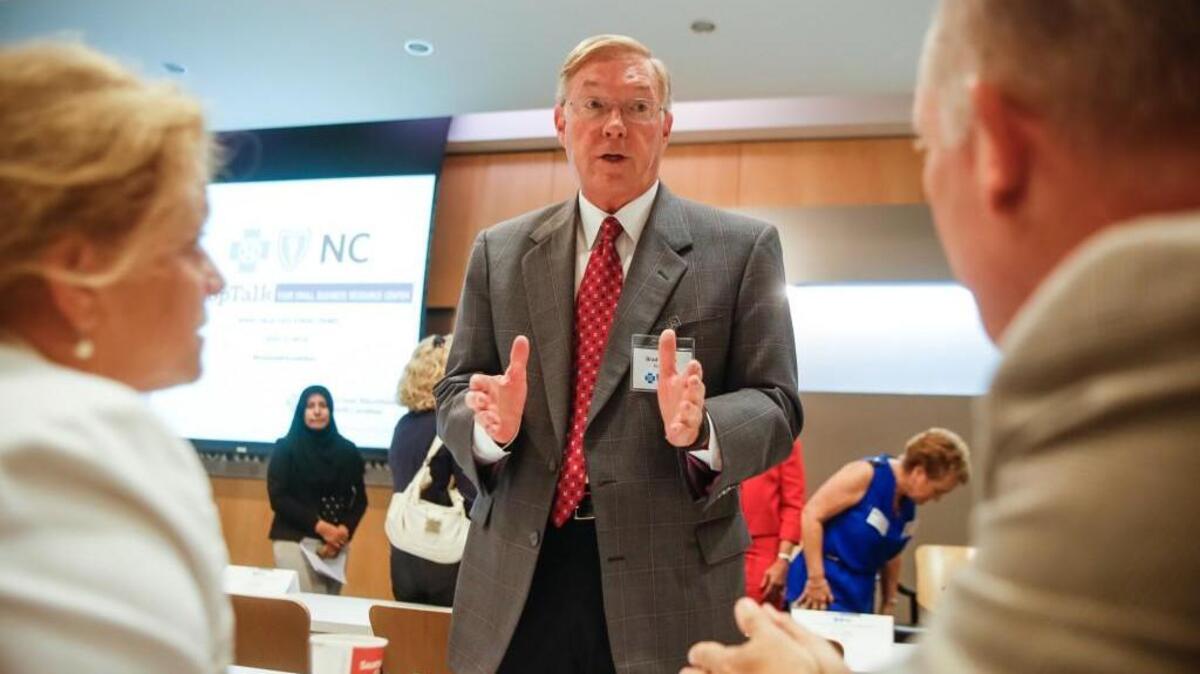 BlueCross BlueShield CEO Brad Wilson speaks with Tamara McCulloch, left, and Gary Bolt during a ShopTalk breakfast focused on small business owners growing their business in Durham on Monday, Aug. 5, 2014.
