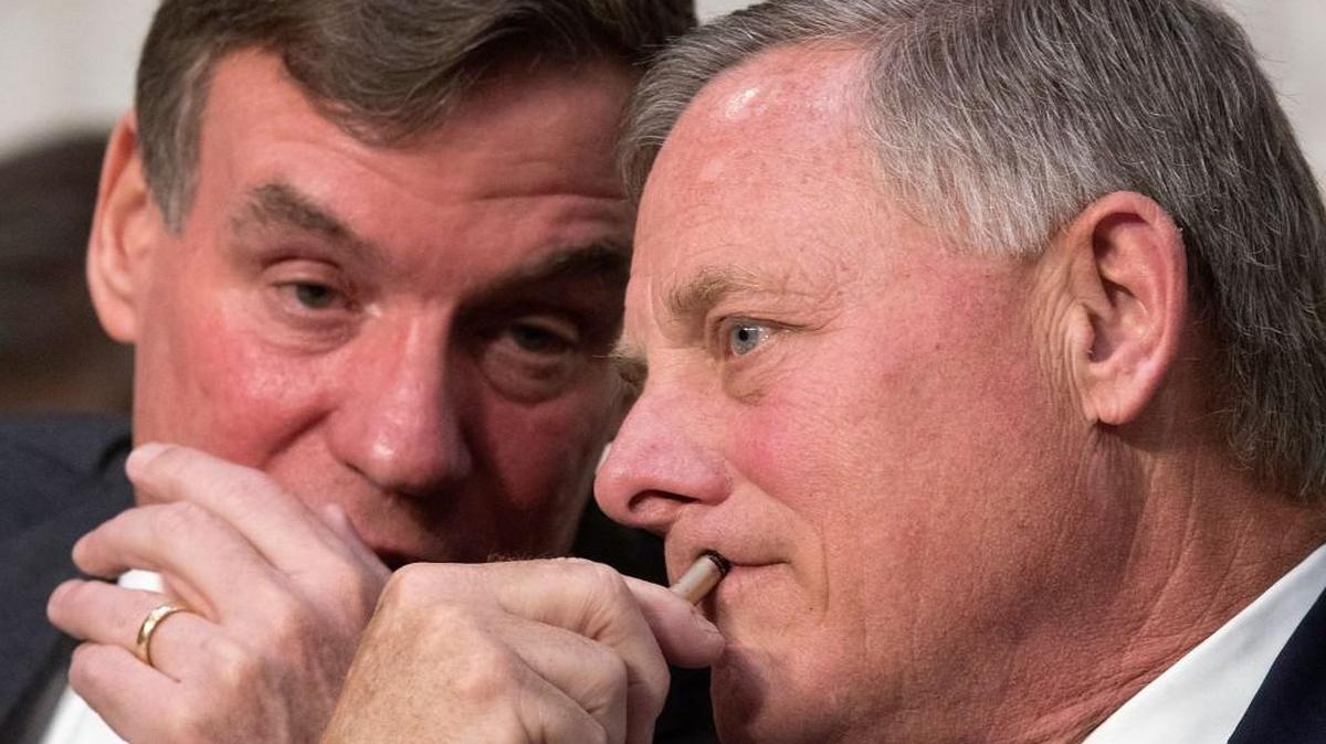 Ranking Democratic Sen. Mark Warner of Virginia, left, and Sen. Richard Burr, right, of the Senate Intelligence Committee