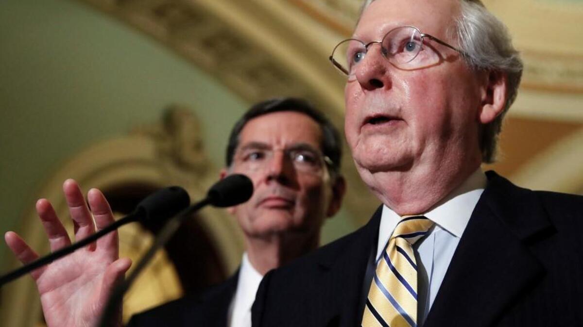 In this July 26, 2017 photo, Sen. John Barrasso, R-Wyo. watches at left as Senate Majority Leader Mitch McConnell of Ky. speaks during a news conference on Capitol Hill in Washington, after the Senate voted on health care legislation. Republican hopes for repealing and replacing President Barack Obama’s health care law are still twitching in Congress,