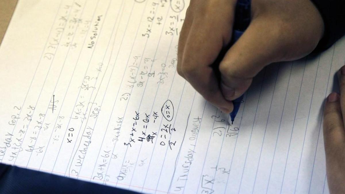 A student works a problem during a math class at Athens Drive High School in Raleigh on Sept. 4, 2014.