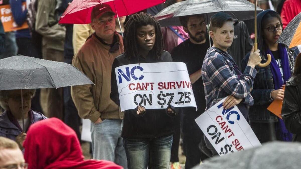 N.C. A&T student Isoka Green, center, demonstrates with hundreds in support of a higher minimum wage during a rally Wednesday, April 15, 2015 at Shaw University in Raleigh.