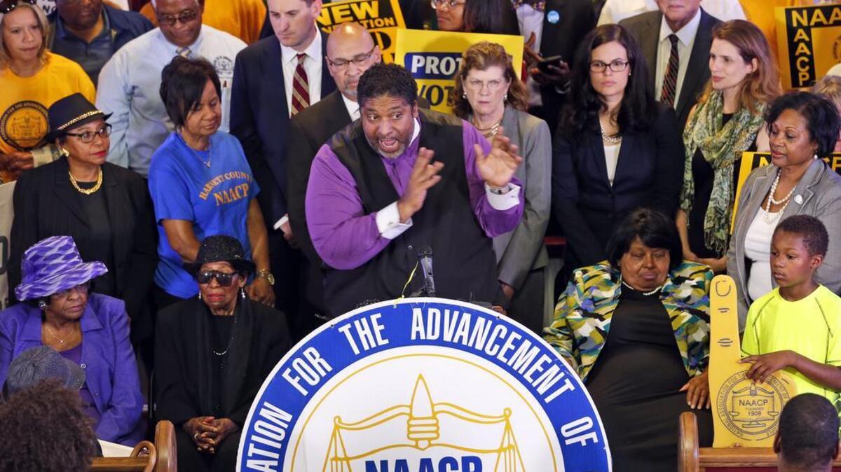 North Carolina NAACP president, Rev. William Barber, center at podium, gestures during a news conference in Richmond, Va., June 21. A federal appeals court on July 29 blocked a North Carolina law that required voters to produce photo identification and follow other rules disproportionately affecting minorities. The state’s request that the Supreme Court suspend the ruling pending appeal failed.