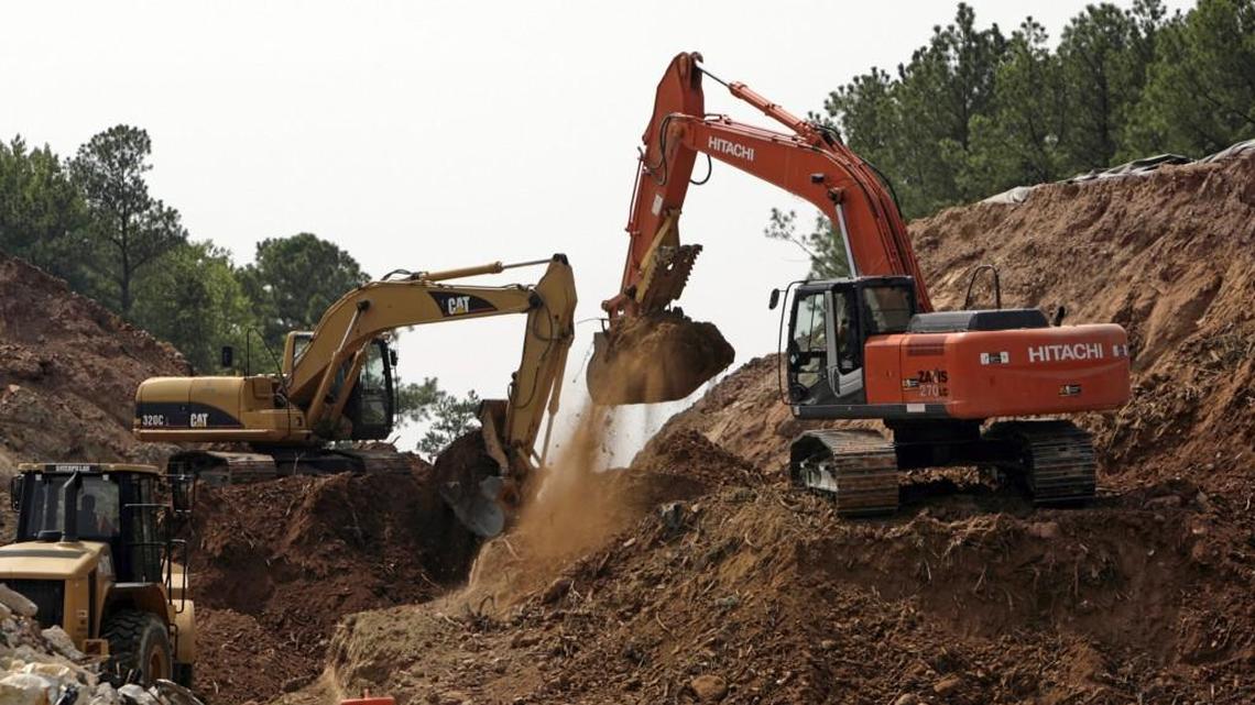 Heavy equipment moves contaminated dirt at the site of the old Ward Transformer facility near the RDU Airport in Raleigh Tuesday afternoon August 5th, 2008. The site is a Superfund cleanup site; about 150,000 tons of ground were soiled by the PCB's in the transformers. Contaminated soil is dug up and heated in a giant industrial dryer, causing the pollutants to vaporize. In a second step, the PCB vapors are destroyed in an afterburner and the gases scrubbed and vented through the stack.