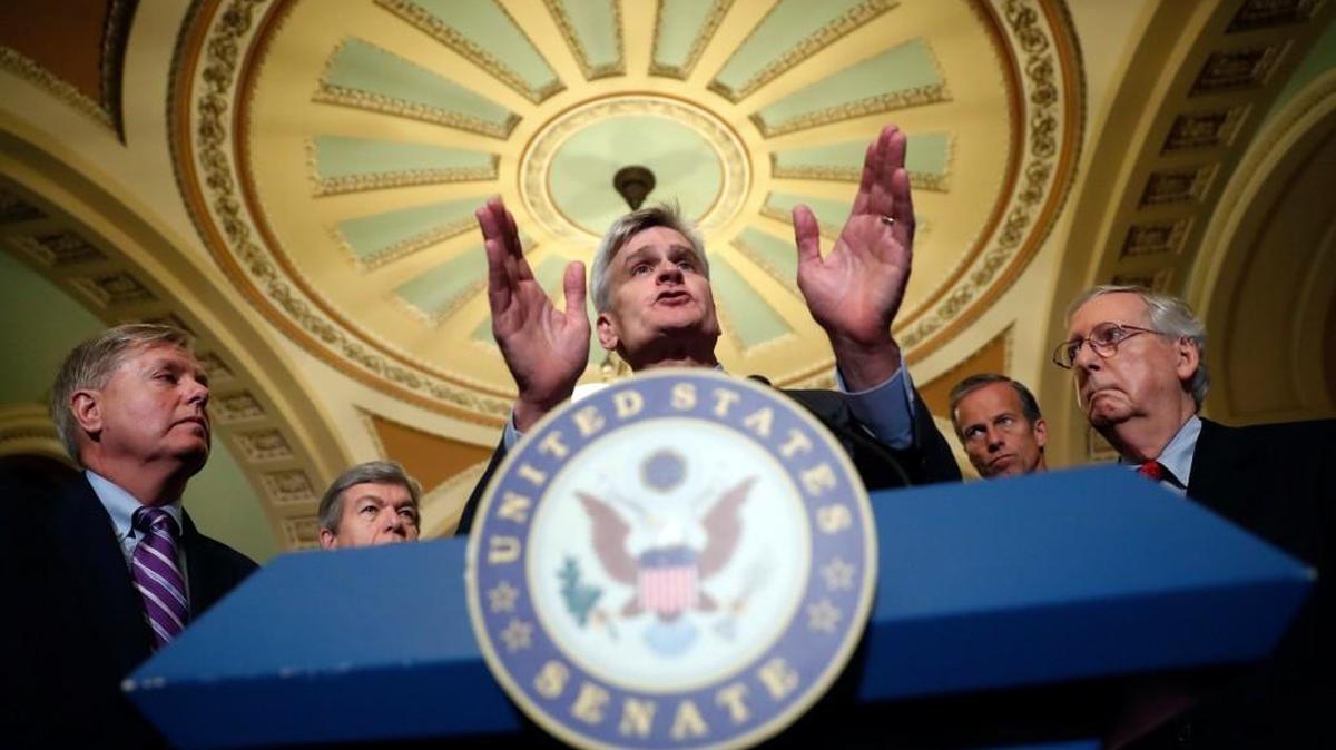 Sen. Bill Cassidy, R-La., center, speaks to the media, accompanied by Sen. Lindsey Graham, R-S.C., left, Sen. Roy Blunt, R-Mo., Sen. John Thune, R-S.D., and Senate Majority Leader Mitch McConnell of Ky., on Capitol Hill, Tuesday, Sept. 19, 2017, in Washington.