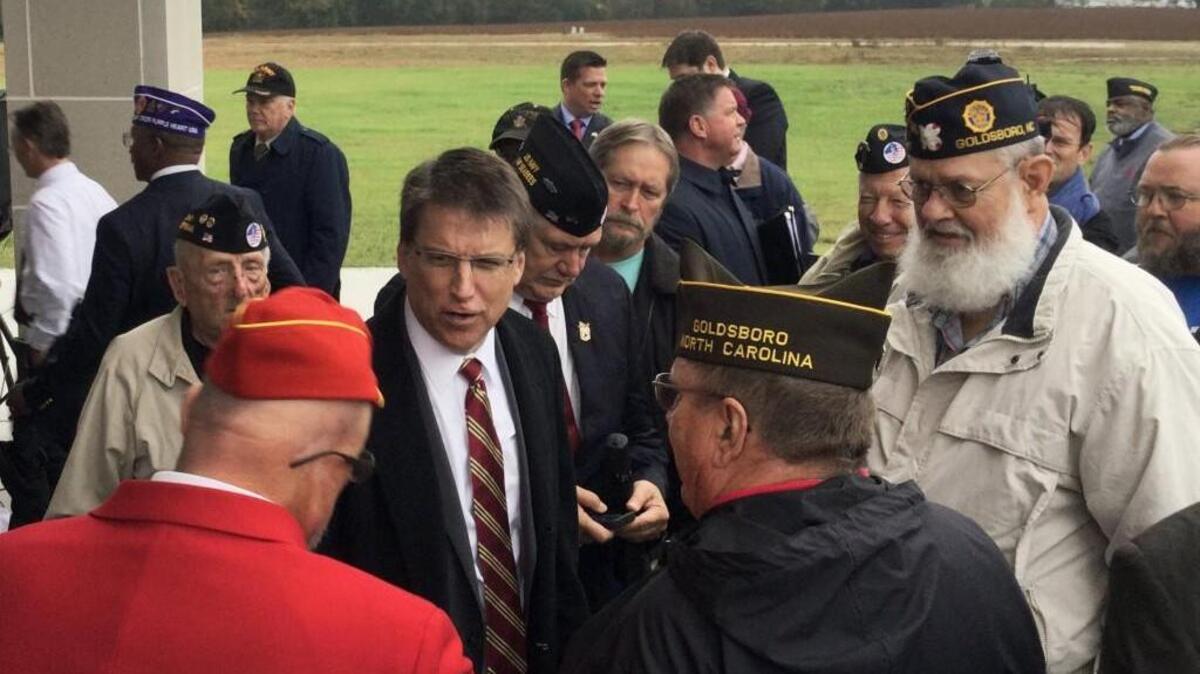 Gov. Pat McCrory, center, greets a group of Goldsboro veterans following the dedication of the new Eastern Carolina State Veterans Cemetery in Goldsboro in November 2015. The cemetery is the fourth state-run veterans cemetery.
