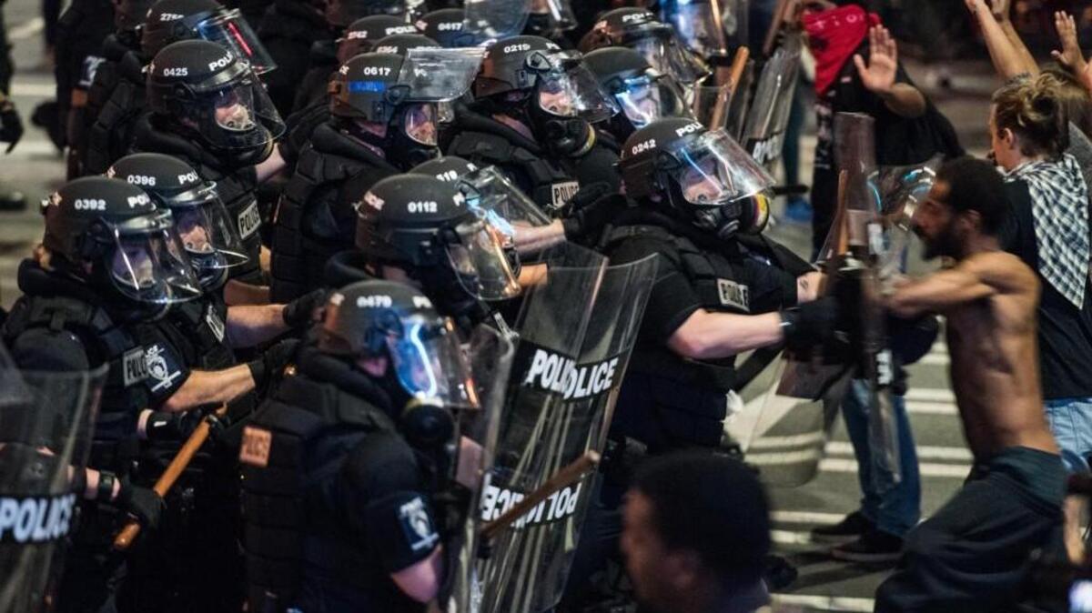Police officers and demonstrators confront each other Wednesday in downtown Charlotte.
