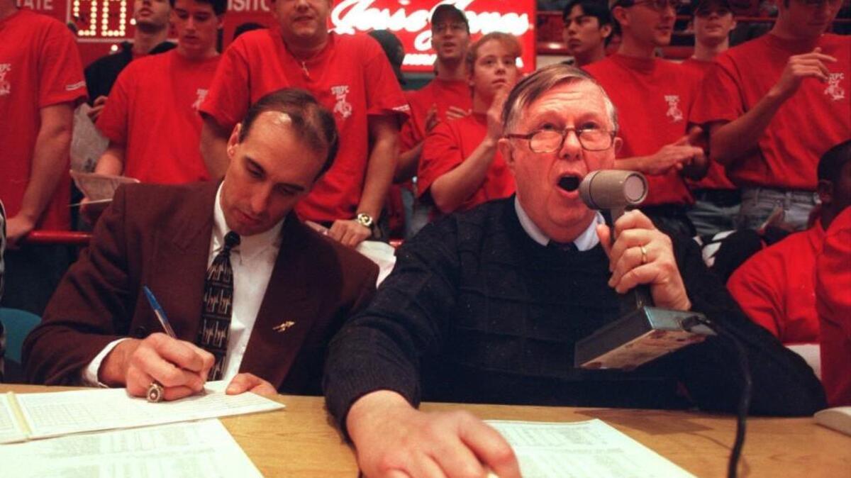 C.A. Dillon, the public address announcer at N.C. State, welcomes fans to game with Florida State Jan. 13, 1996. At left is Bob Burda, assistant sports information director at Florida State University.