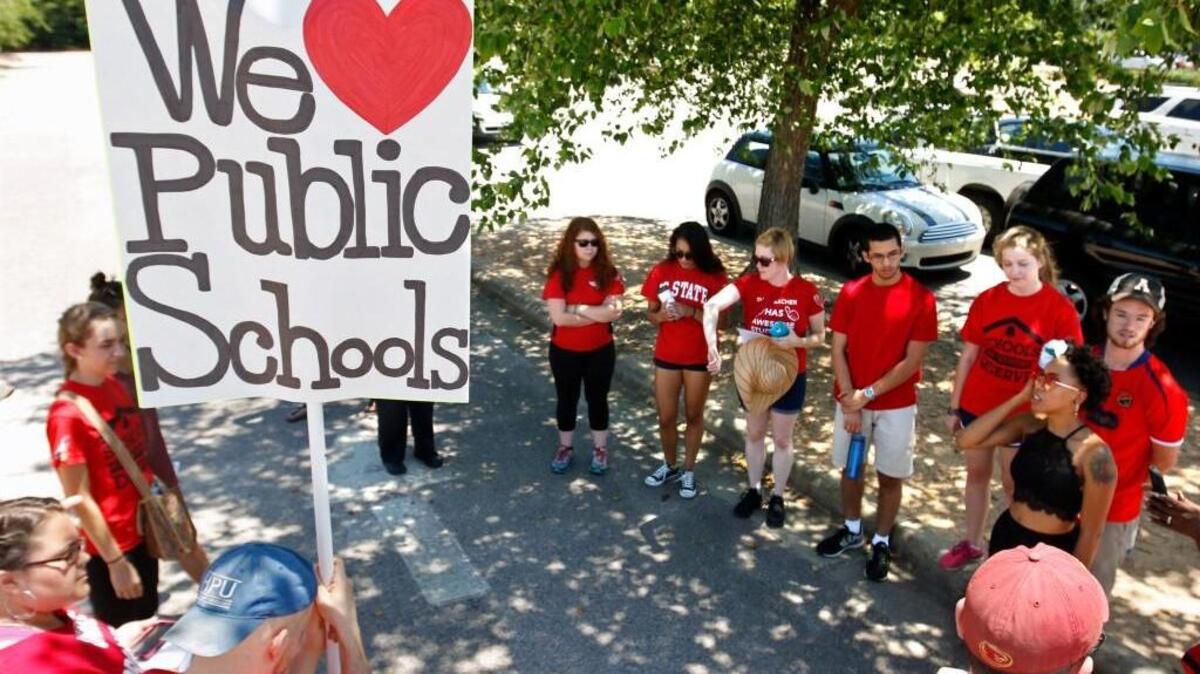 Members of the Students Deserve More march group of about 16 teachers, students and parents from across NC met briefly at their starting point at Wakefield High School in north Raleigh before heading down Wakefield Pines Drive.