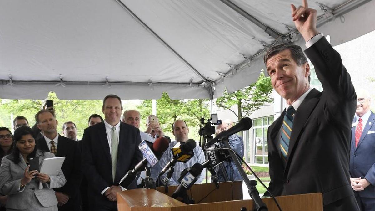 N.C. Gov. Roy Cooper points to the sky and comments on the rain as he spoke during an announcement at the Credit Suisse company in Morrisville, N.C., Tuesday , May 9, 2017. The company which has 1,700 employees in the Triangle, New York and Princeton, N.J. announced, due to the repeal of HB2, they will be bringing 1000 new jobs to their N.C. operation.
