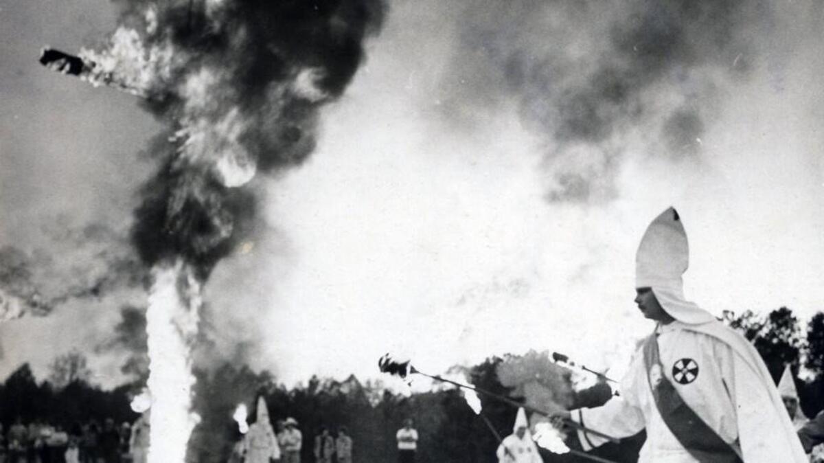 A Ku Klux Klan cross lighting at a rally near Benson on April 21, 1980.