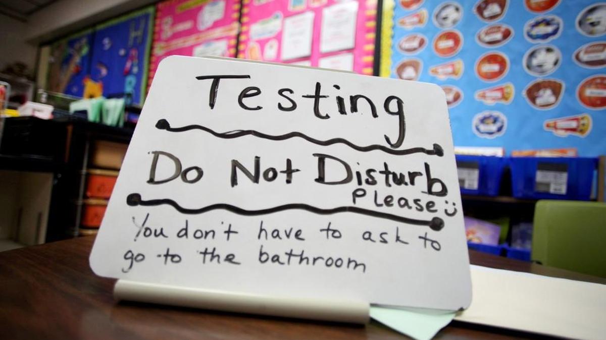 This sign sits on the desk of a third grade teacher on Tuesday, April 29, 2014, in Naperville, Ill. Standardized testing has become a big part of a child’s education.