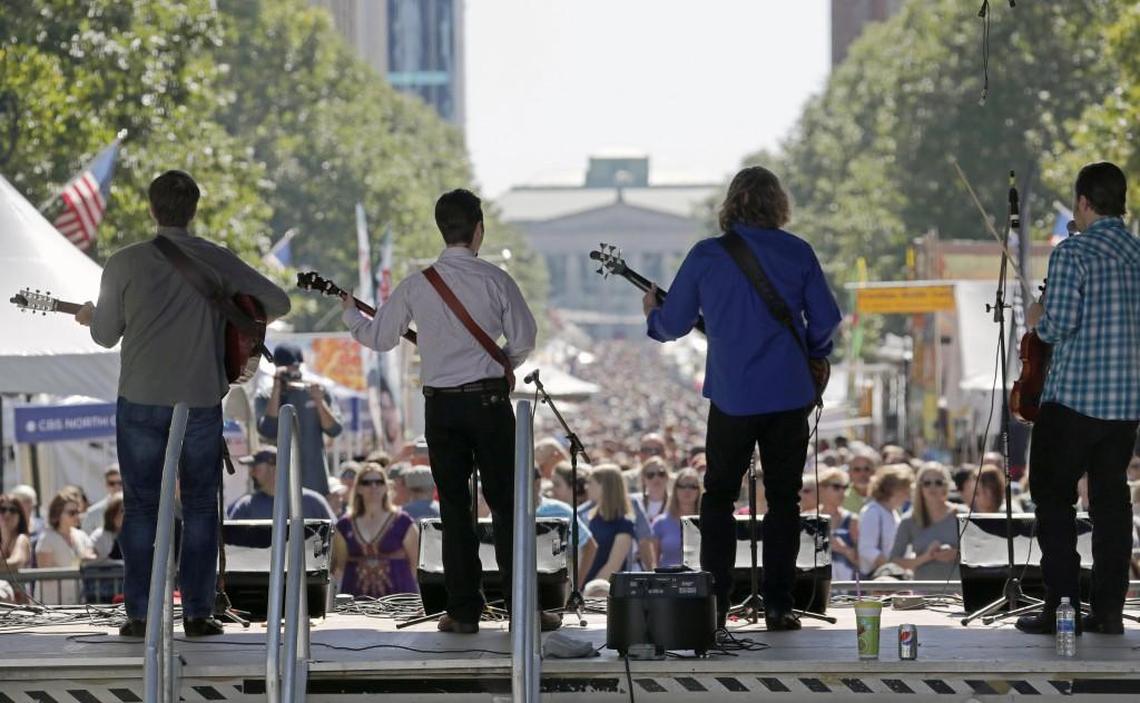 Roy Carwell and Tennessee Moon perform on a stage near the Capitol as thousands crowd Fayetteville St. to enjoy the Wide Open Bluegrass festival in downtown Raleigh, NC, on Sept. 30, 2017. The Progress Energy Center for the Performing Arts/Memorial Auditorium is in the background, center.