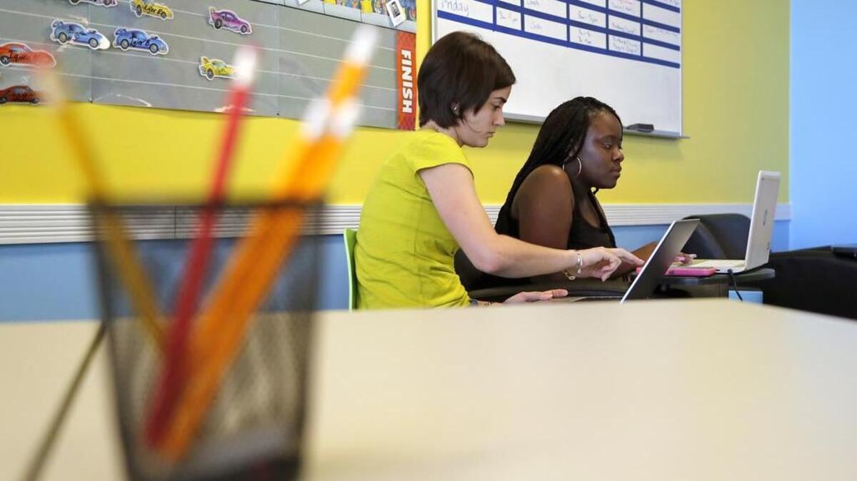 Teacher Brittany Feldmann, left, works with student Chamonta Artis on an English lesson at the Wake Acceleration Academy in Garner on June 27, 2017. The Wake County school system plans to start its own dropout recovery academies so it’s ending its relationship with a for-profit company that ran the program.