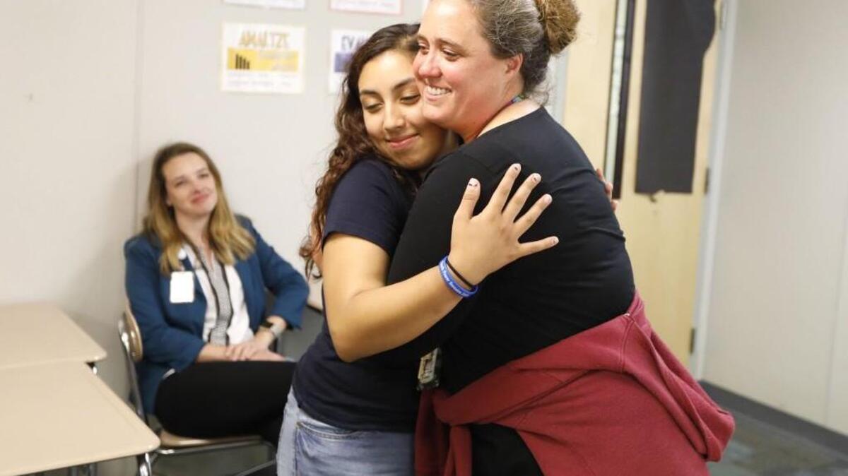 Megan Walter gets a hug from student Emily Paz after Walter was named Wake County’s 2017 School Counselor of the Year during a surprise ceremony at Wakefield High School in Raleigh on May 24. Wake County plans to increase its number of school counselors to match the national ratio of counselors to students.