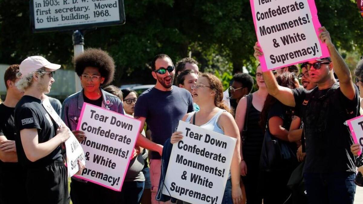Protesters who want Confederate monuments removed from state grounds chant outside the building after the N.C. Historical Commission voted to delay action on a recommendation about removing statues from state sites during a meeting at the Archives and History Building in Raleigh, NC, on Sept. 22, 2017. Activist on both sides of the issue were present at the meeting.