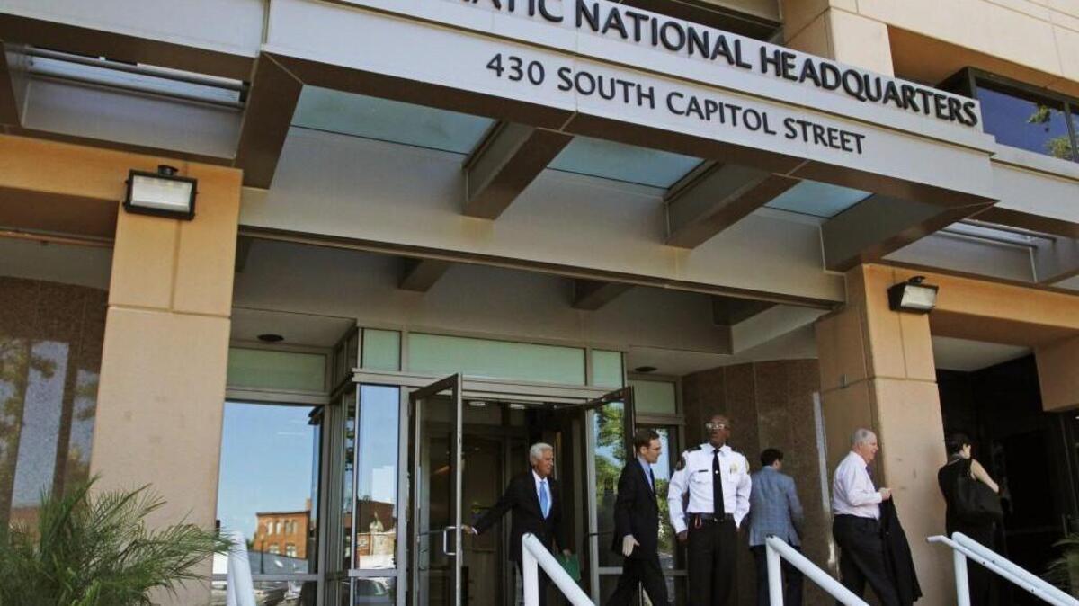 In this June 14 photo, people stand outside the Democratic National Committee (DNC) headquarters in Washington. The computers of the House Democratic campaign committee have been hacked, an intrusion that investigators say resembles the recent cyber breach of the Democratic National Committee for which the Russian government is the leading suspect.