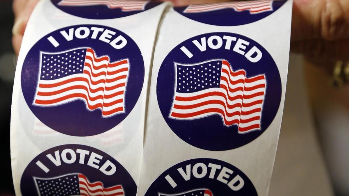 Voters are offered a sticker as they cast their ballots as hundreds came out on the first day of early voting at the Hope Mills Recreation Center in Hope Mills on Oct. 20, 2016.