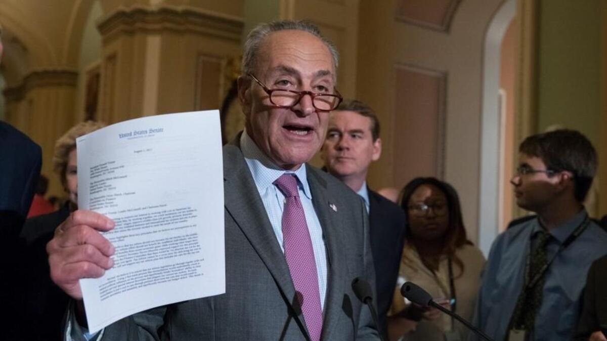 Senate Minority Leader Chuck Schumer of N.Y., joined by Sen. Michael Bennet, D-Colo., right, talks about a letter he sent to President Donald Trump, Senate Majority Leader Mitch McConnell of Ky., and Senate Finance Committee Chairman Sen. Orrin Hatch, requesting a bipartisan effort on tax reform, Tuesday, Aug. 1, 2017, during a news conference on Capitol Hill Washington.