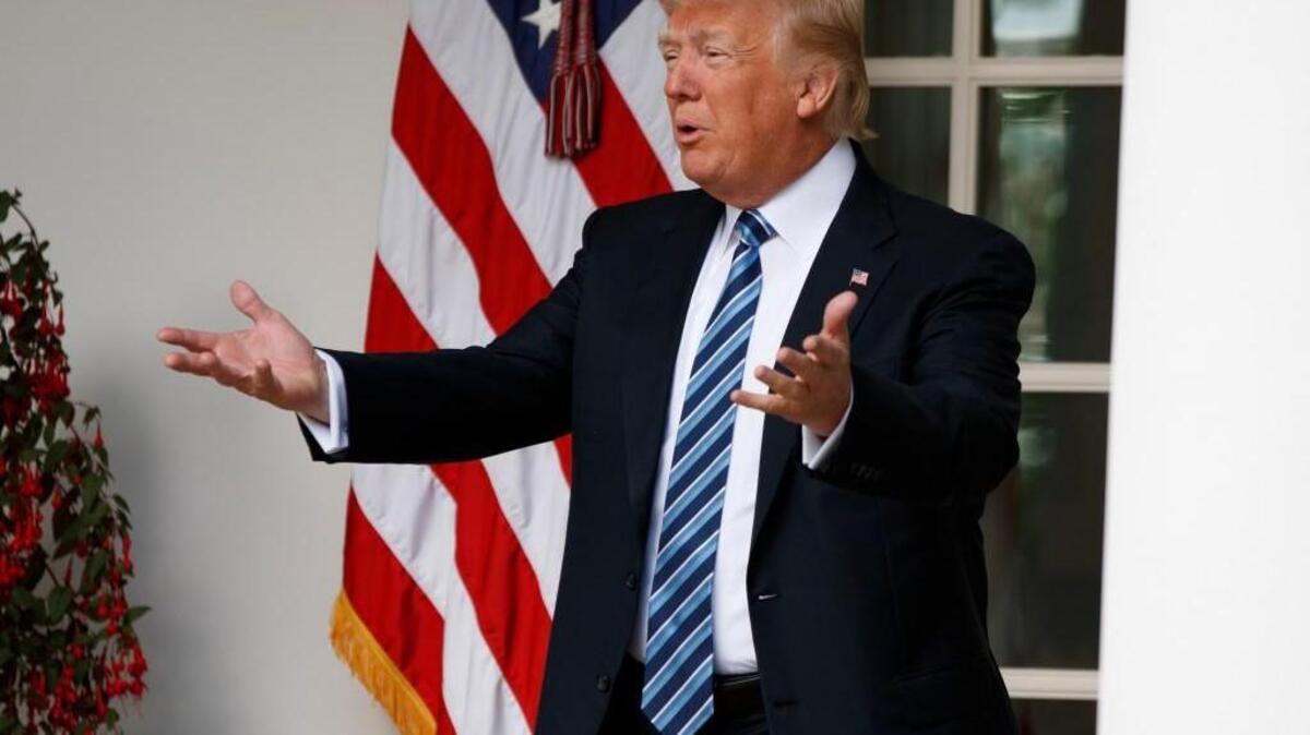 President Donald Trump talks with reporters as he walks to the Oval Office of the White House in Washington, Tuesday, May 2, 2017. President Donald Trump says the nation "needs a good ‘shutdown’ in September" to fix a "mess" in the Senate, saying on Twitter that the country needs to "either elect more Republican Senators in 2018 or change the rules now to 51 (percent)," suggesting more rules changes ahead in the Senate.