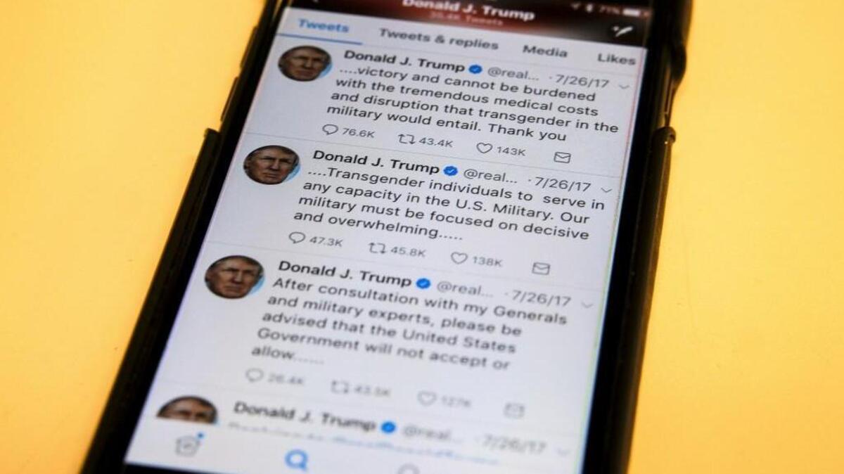 President Donald Trump's twitter feed is photographed on a mobile phone in Washington, Thursday, Aug. 3, 2017.