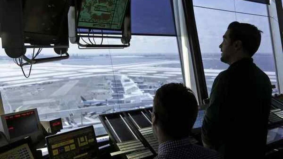 In this March 16, 2017 photo, air traffic controllers work in the tower at John F. Kennedy International Airport in New York.