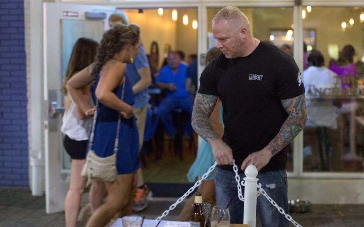 The Anchor Bar bouncer Adam Young closes the sidewalk patio just before 1 a.m. Saturday, Aug, 22, 2015 in downtown Raleigh.