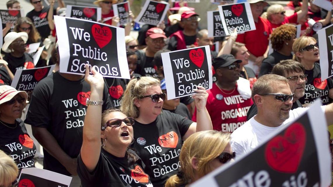 Educators marched from NCAE headquarters to the legislature on June 25, 2014, calling on lawmakers to give teachers better pay.