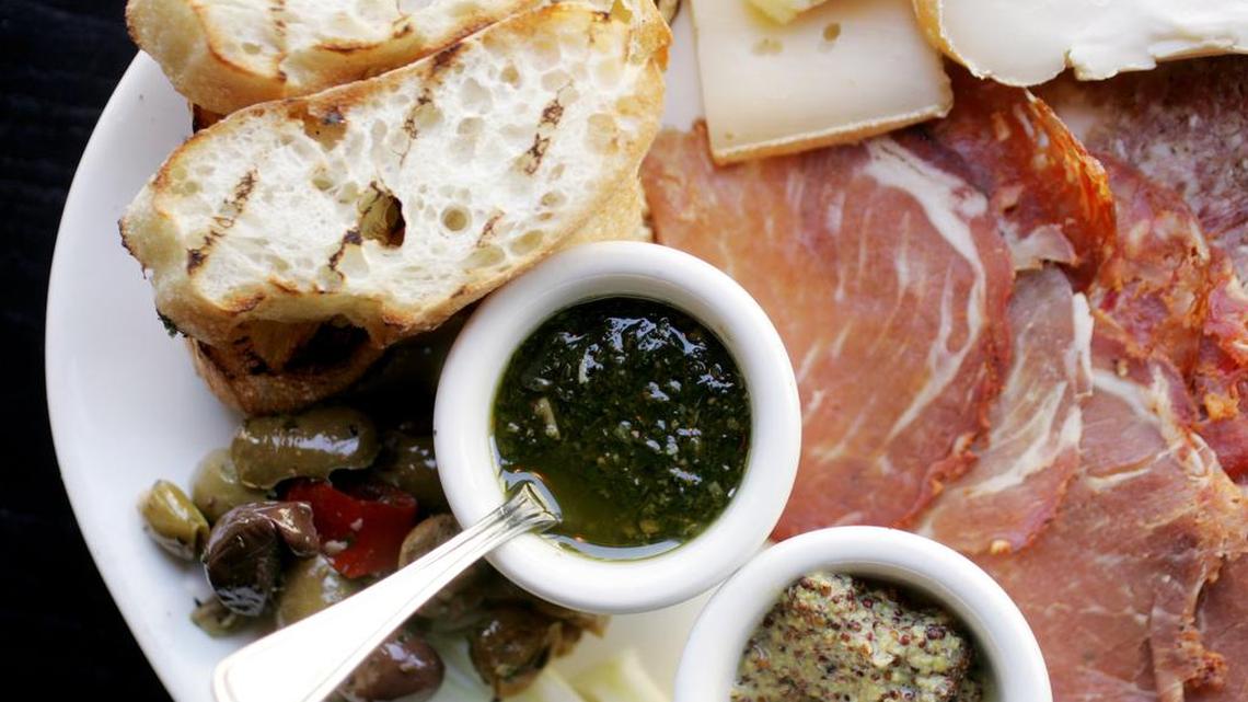 The Salumi (Antipasta) is a plate made up of hot coppa, toscona salami, finnochiona, talleggio, pecorno genepro, fontina valle b'aosta, marinated olives, raw julienne fennel, crostini with pine nut pesto and whole grain mustard at Gravy in downtown Raleigh.