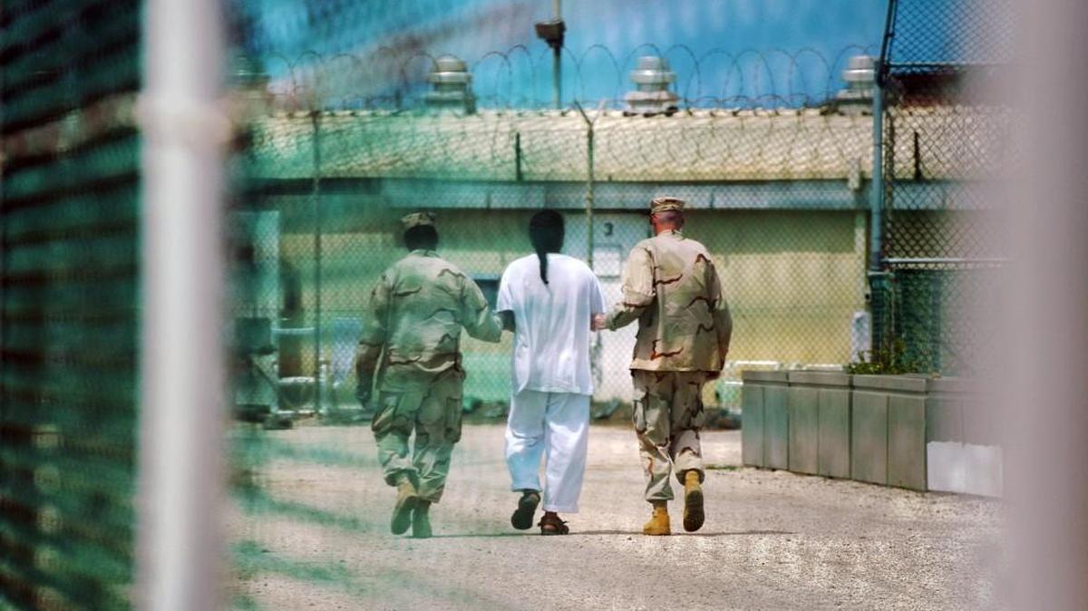 A detainee is escorted at Camp Delta detention facility in Guantanamo Bay, Cuba.
