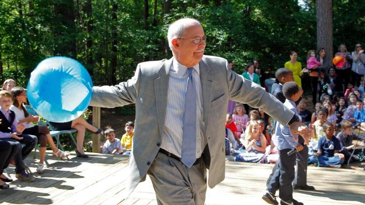 Dr. Jim Merrill, Wake County Superintendent of Schools, throws a beach ball into the crowd to get things rocking at a celebration held at Combs Elementary School after it was named the best magnet school in the country on May 19, 2014.