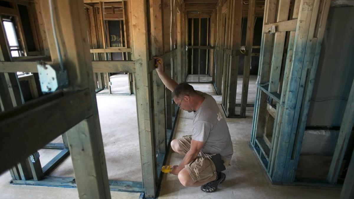 Contractor Tim Warner works on a hurricane-damaged home in Lumberton