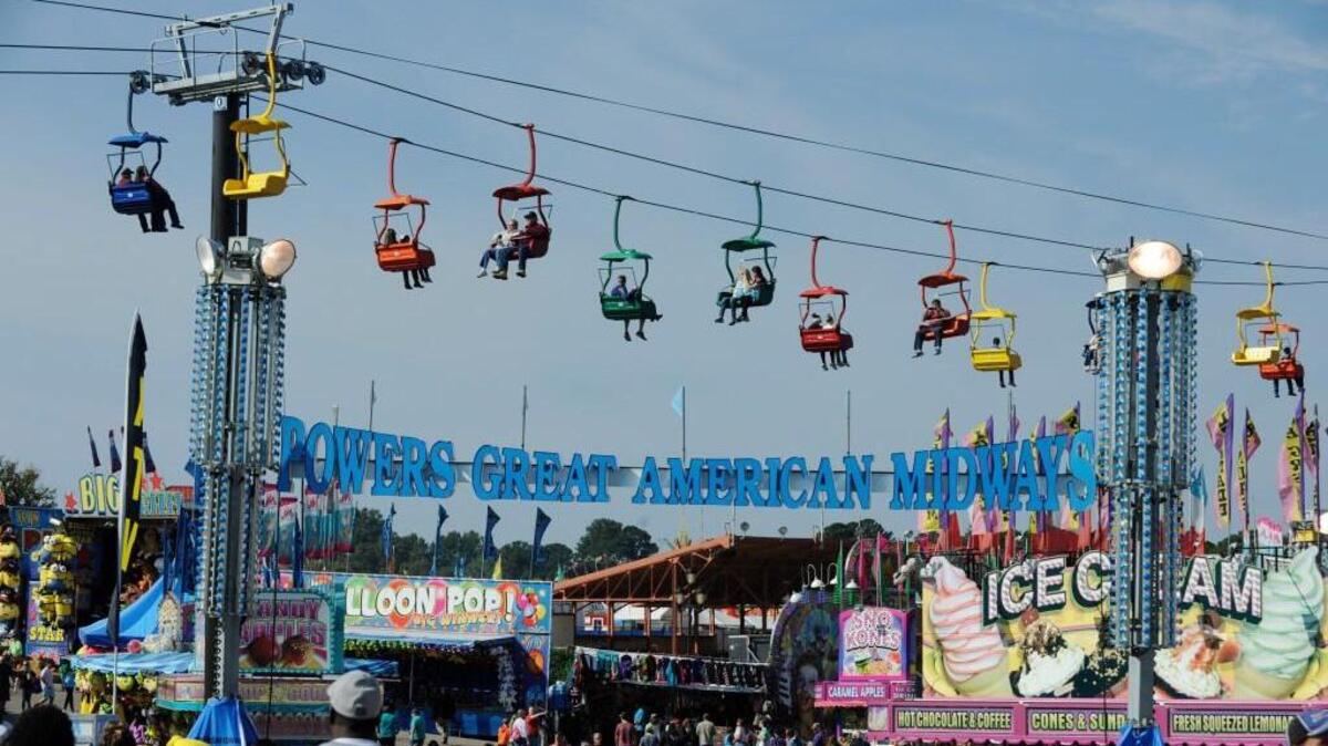 Passengers ride the State Fair Flyer above the fair's midway in Raleigh, N.C. on Saturday, October 15, 2016.