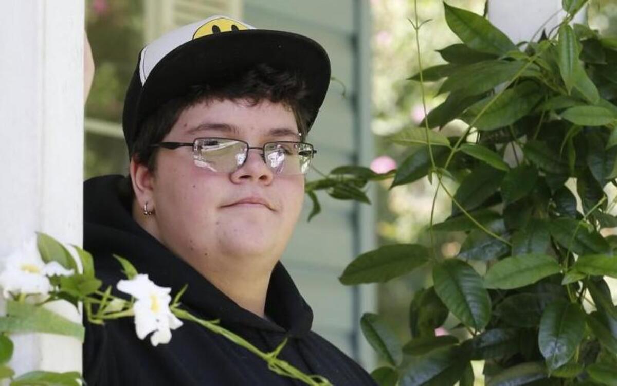 FILE This Tuesday Aug. 25, 2015 file photo shows Gavin Grimm on his front porch during an interview at his home in Gloucester, Va. A U.S. appeals court has overturned a policy barring a transgender student from using the boys’ restrooms at his Virginia high school. A three-judge panel of the 4th U.S. Circuit Court of Appeals ruled Tuesday, April 19, 2016 that the Gloucester County School Board policy is discriminatory. A federal judge had earlier rejected Grimm's sex discrimination claim. (AP Photo/Steve Helber)