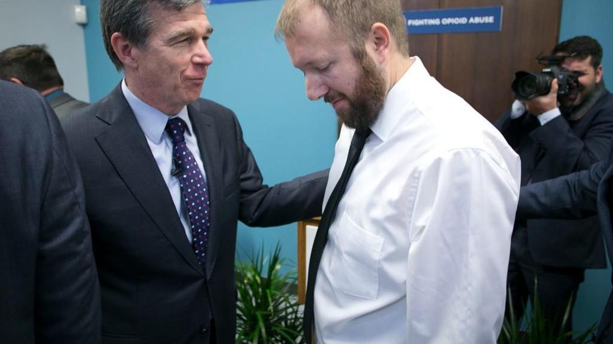 Gov. Roy Cooper embraces recovering addict Aaron Gable in May after a press conference where Gable told his story of opioid addiction and the road to recovery at the SouthLight Healthcare facility on Garner Road in Raleigh.