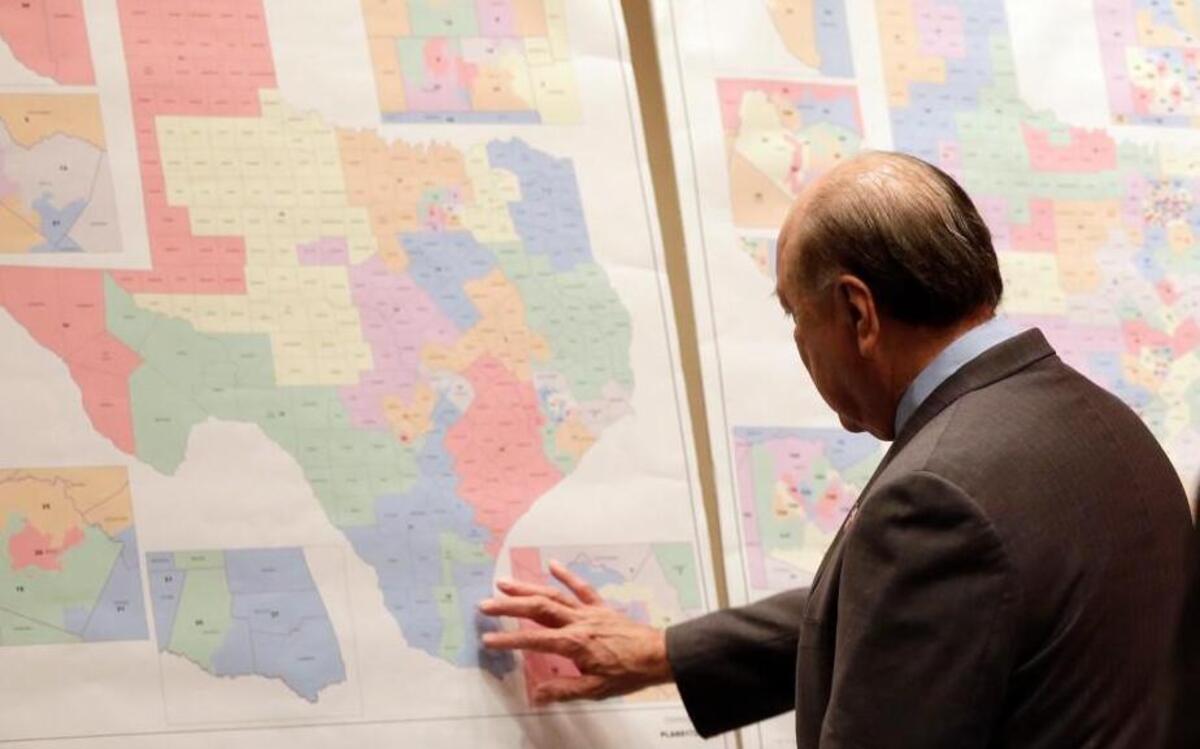 Texas state Sen. Juan “Chuy” Hinojosa looks at maps on display prior to a Senate redistricting committee hearing in 2013. The U.S. Supreme Court handed Texas a victory this week, upholding the state’s system of drawing legislative voting districts based on everyone who lives there, not just registered voters.