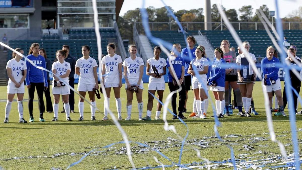 The Duke players look through the streamers that fly for victorious Penn State after they lost at the conclusion of the NCAA Women's College Cup Soccer Finals held at WakeMed Soccer Park in Cary, NC on Dec. 6, 2015.