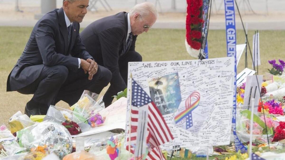 US President Barack Obama and Vice President Joe Biden place flowers for the victims of the Orlando mass shooting at a memorial at the Dr. Phillips Center for the Performing Arts in Orlando last week. / AFP PHOTO / SAUL LOEBSAUL LOEB/AFP/Getty Images