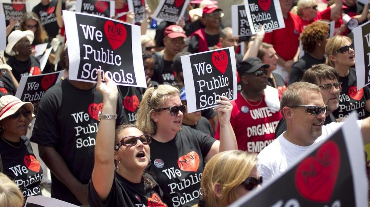 First grade teacher Tara Speicher of Greenville, N.C. rallies with fellow educators on Raleigh’s Bicentennial Mall in 2014 seeking better pay. Teachers did get raises in 2015 and 2016, but their average pay remains near the lowest in the nation.