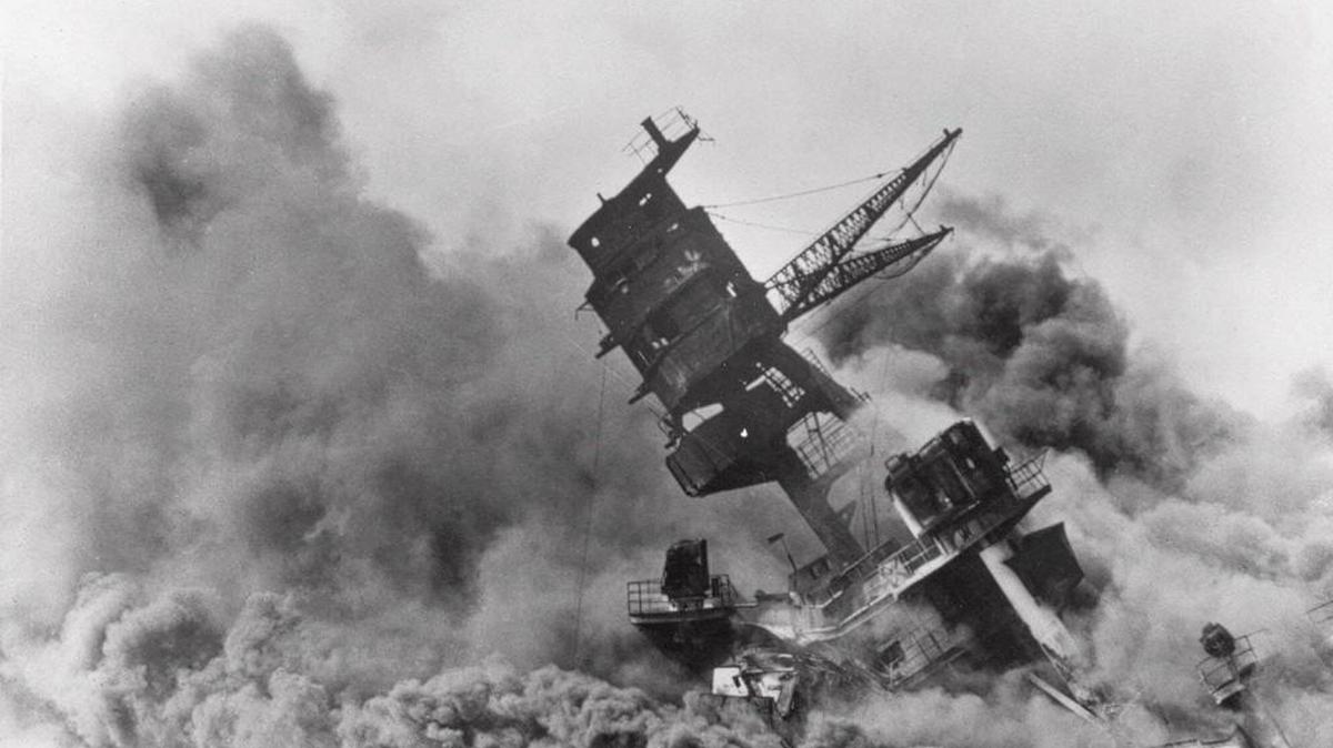 The battleship USS Arizona belches smoke as it topples over into the sea during a Japanese surprise attack on Pearl Harbor, Hawaii, Dec. 7, 1941.